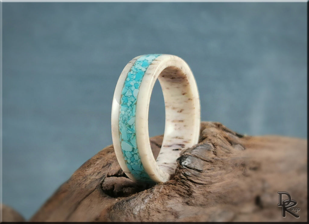 Deer antler ring with turquoise inlay by DR Rings on rustic wooden surface