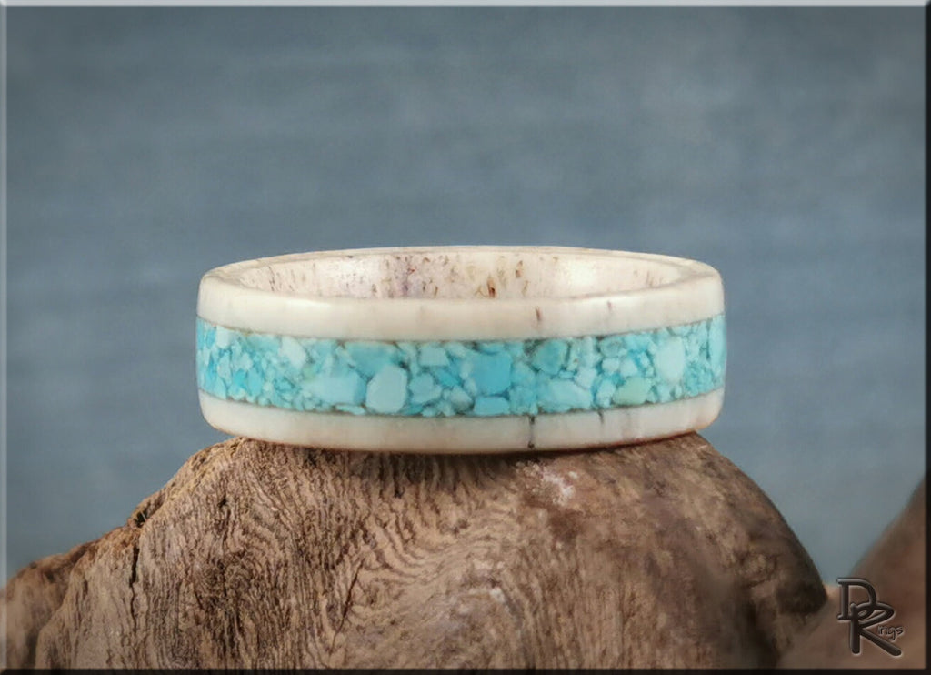 DR Rings deer antler ring with turquoise inlay featuring natural blue stones on wooden background