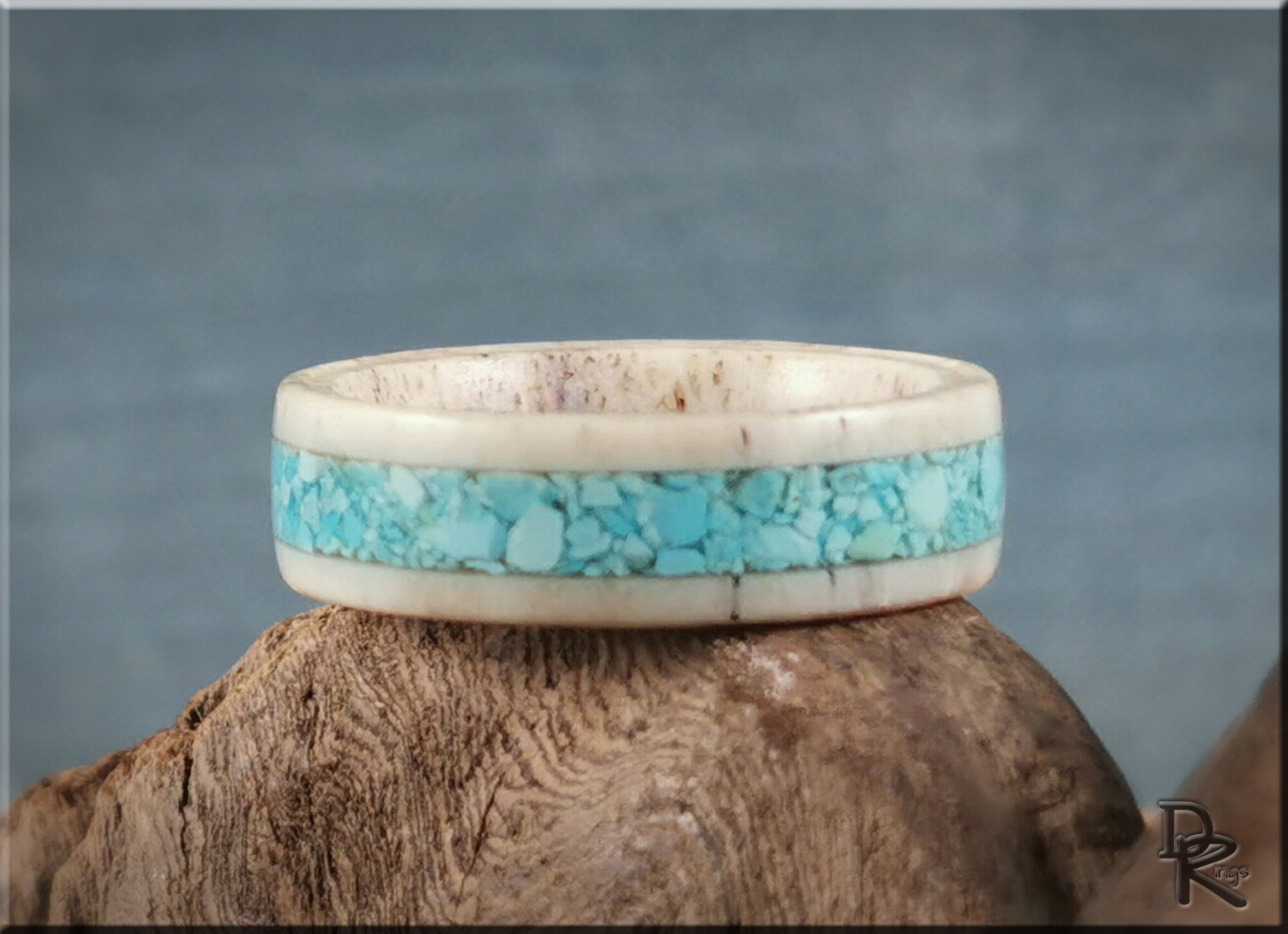 DR Rings deer antler ring with turquoise inlay featuring natural blue stones on wooden background