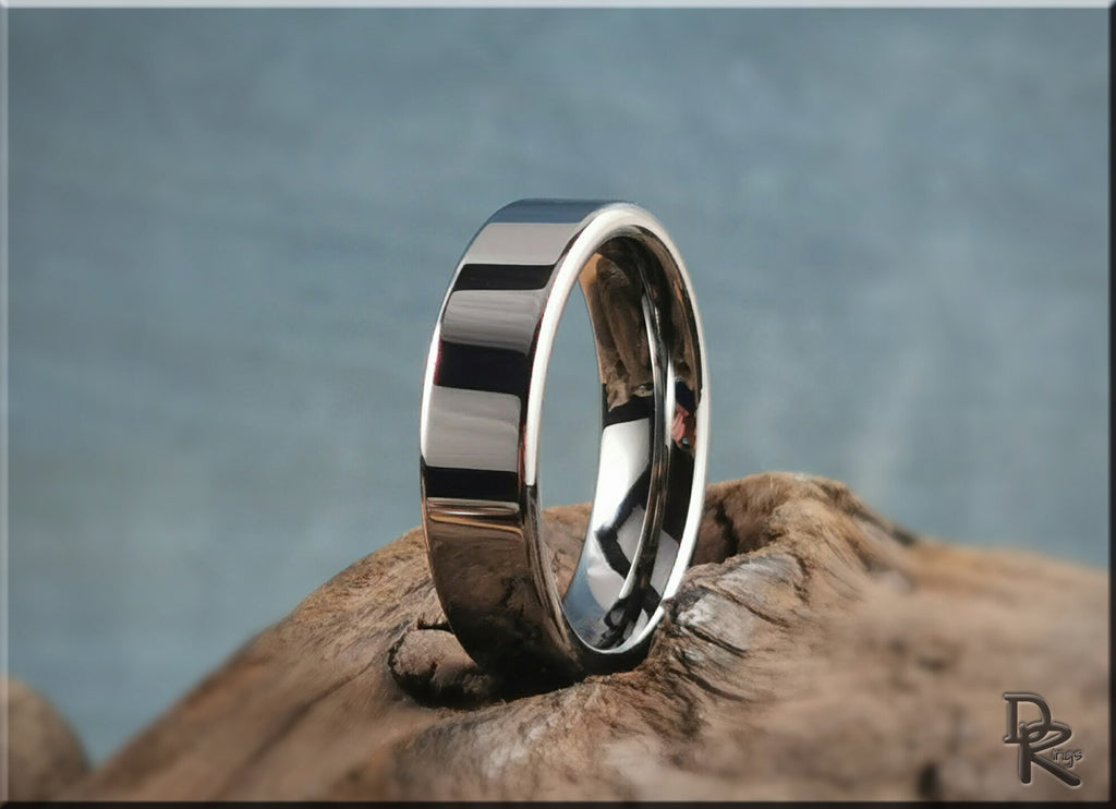 DR Rings polished tungsten ring carbide band with a sleek reflective surface on a natural wood background