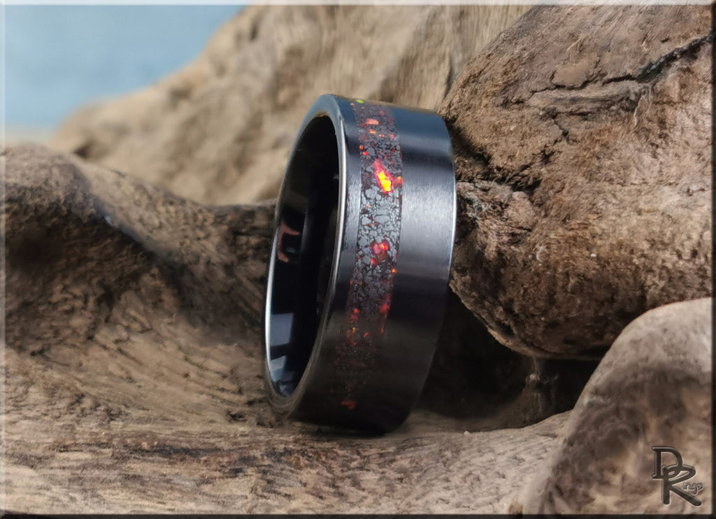 DR Rings black band ring opal inlay with fiery red and orange accents on natural wood background