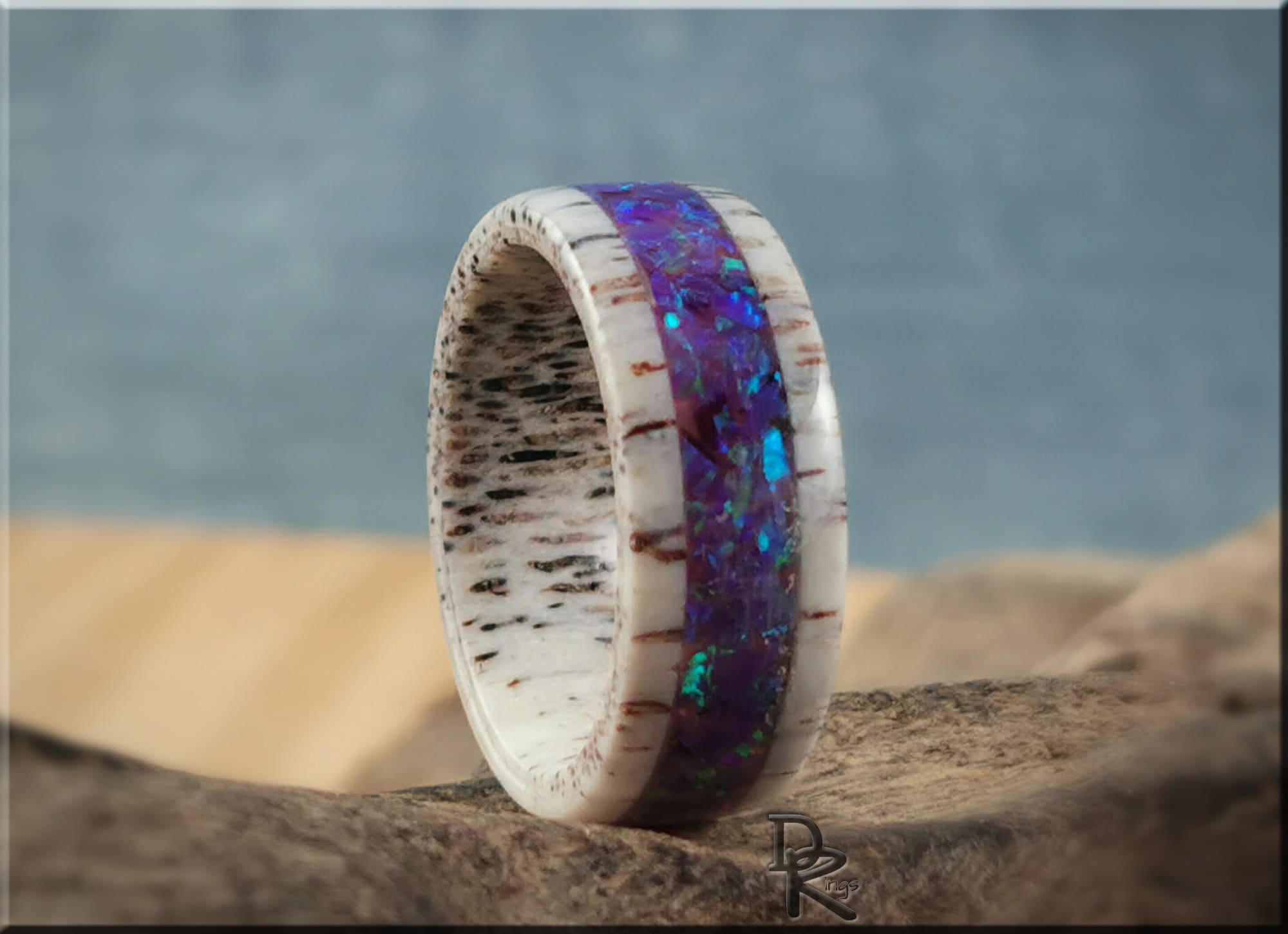 Deer antler ring with opal inlay featuring vibrant blue and purple stones and natural antler texture