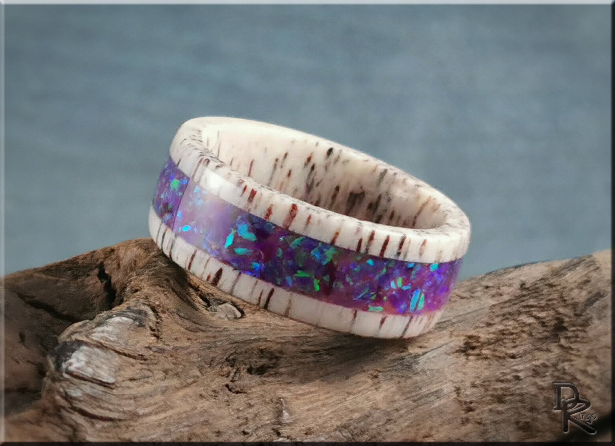 Deer antler ring with opal inlay featuring vibrant purple opal details and natural antler texture