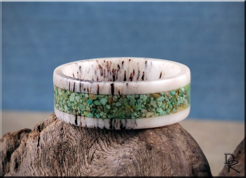 Deer antler ring with turquoise inlay by DR Rings displayed on rustic wood background