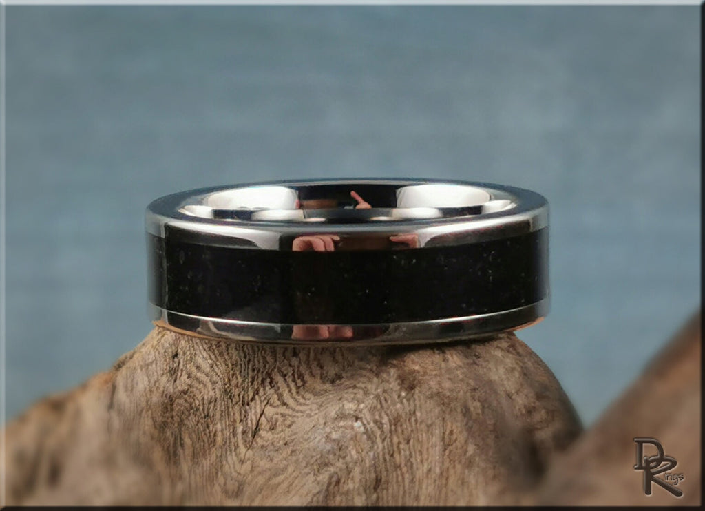 DR Rings tungsten ring with shungite black center band and polished silver edges on wood