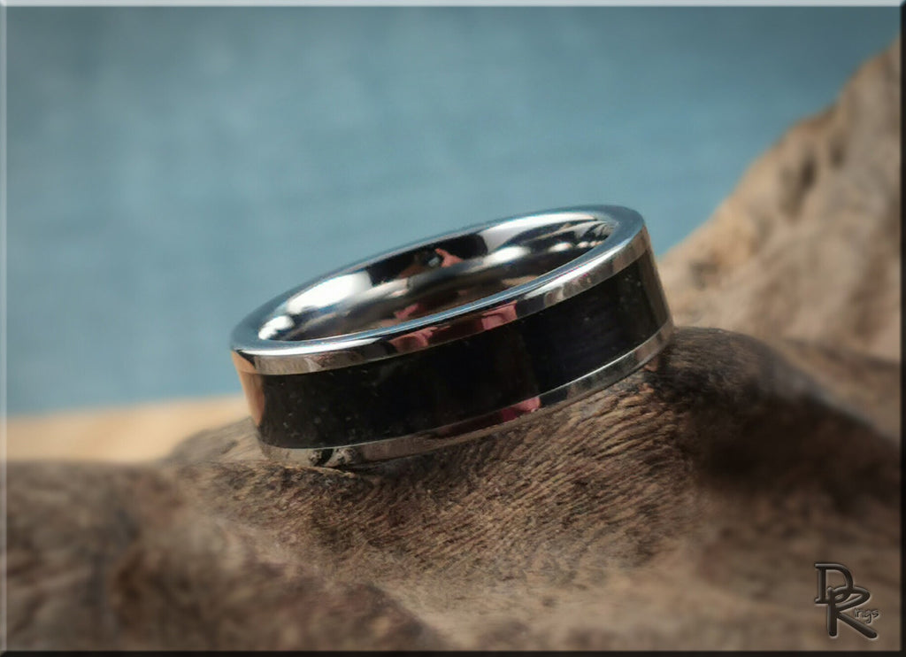 DR Rings tungsten ring with shungite black inlay on a natural wooden surface