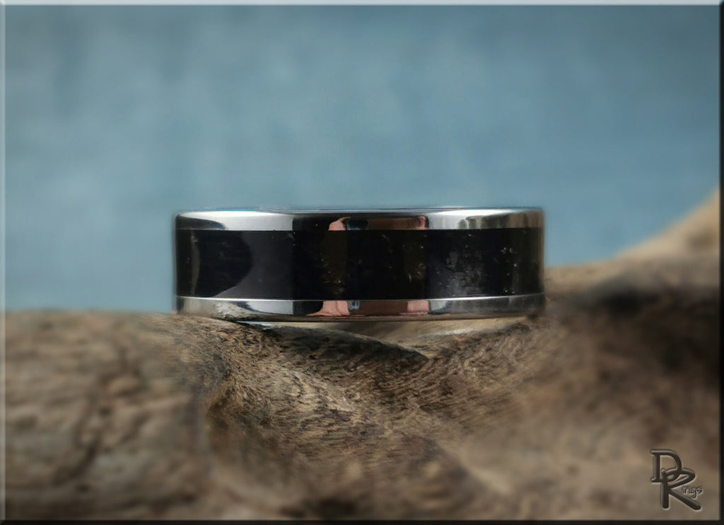 DR Rings tungsten ring with shungite black polished and silver band on textured background