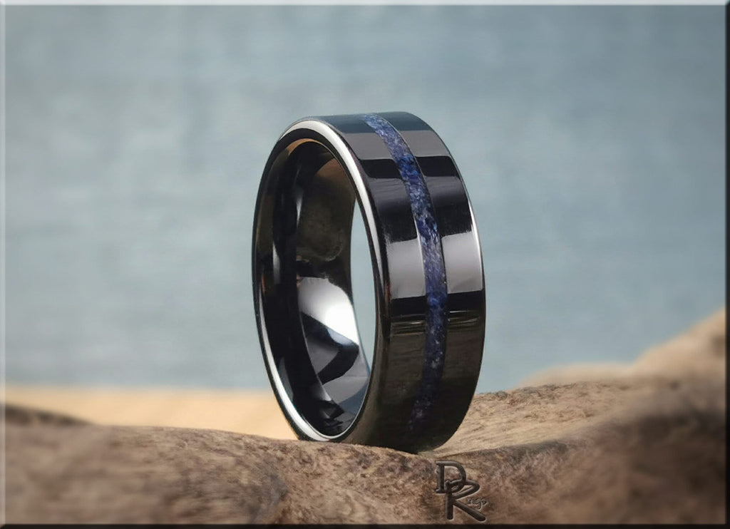 DR Rings black ceramic ring with blue inlay band and polished finish on natural wood background