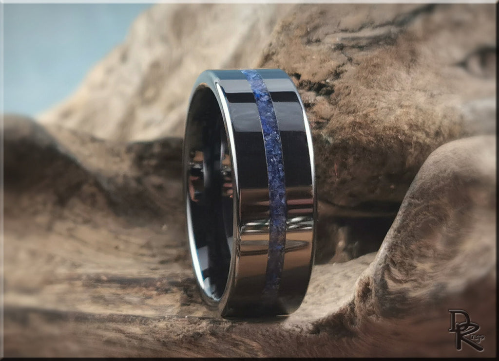 DR Rings black ceramic ring with blue stone inlay and polished finish on natural wood background