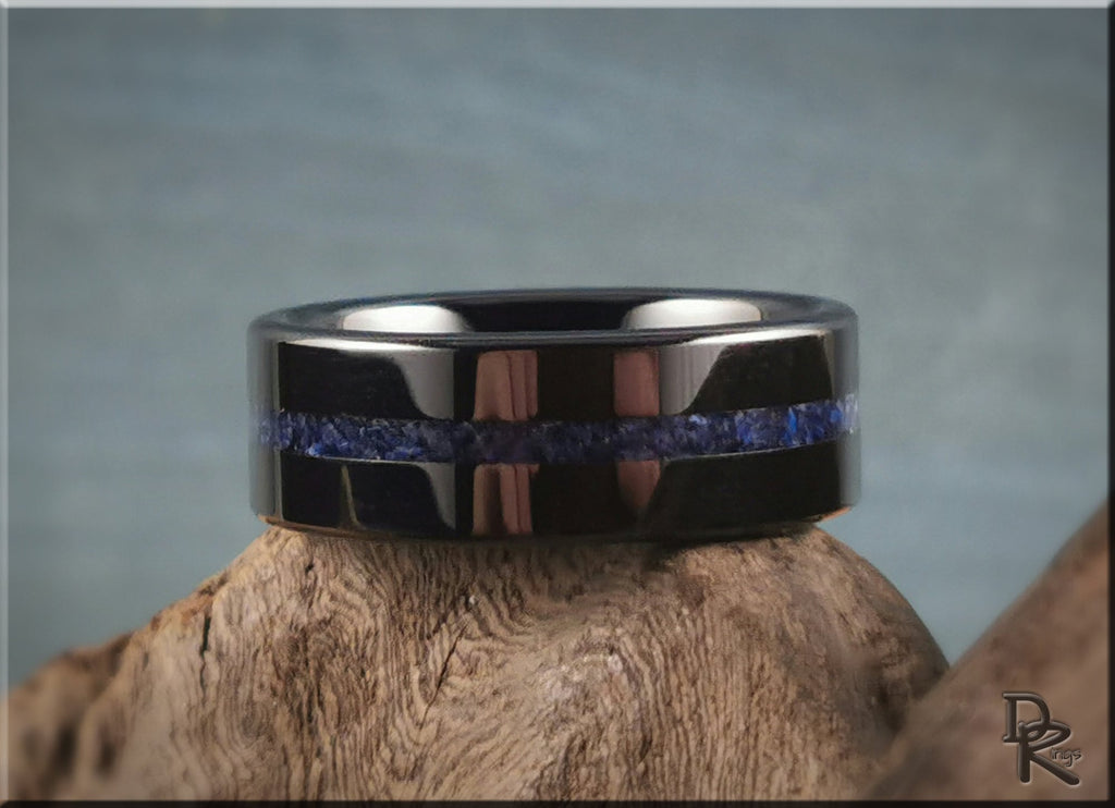 DR Rings black ceramic ring with blue stone inlay on wooden display with gray background