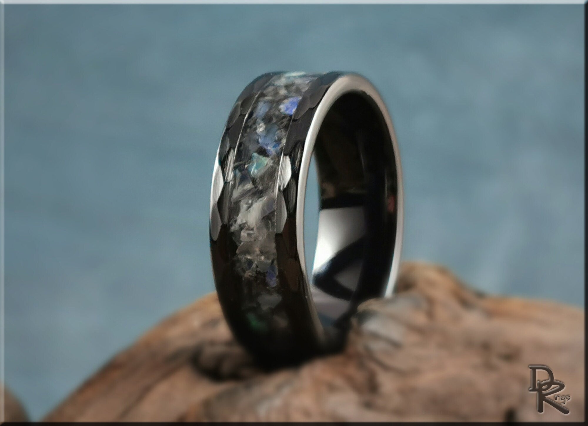 Hammered ceramic ring with inlay featuring dark iridescent stone pattern by DR Rings