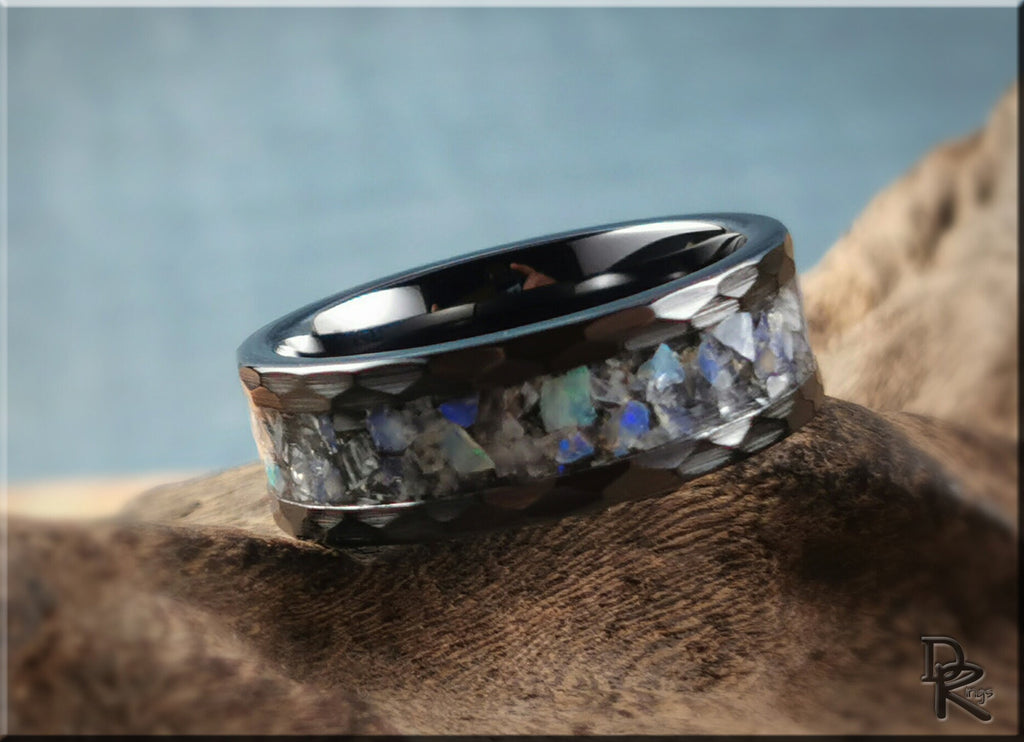 Hammered ceramic ring with inlay featuring blue and white stone accents in black band