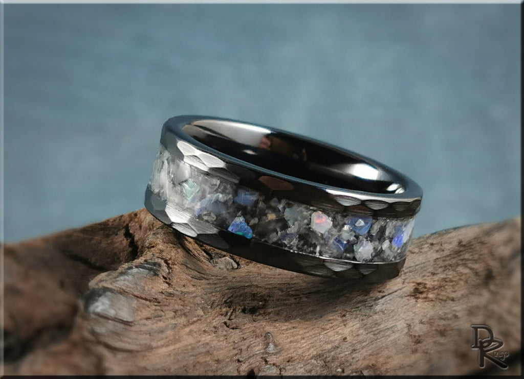 Hammered ceramic ring with inlay featuring iridescent stones set in a dark metal band by DR Rings