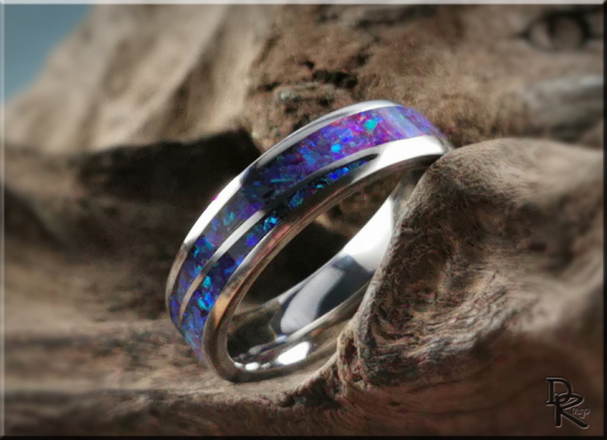 DR Rings titanium ring with opal blue and purple inlay on textured natural background