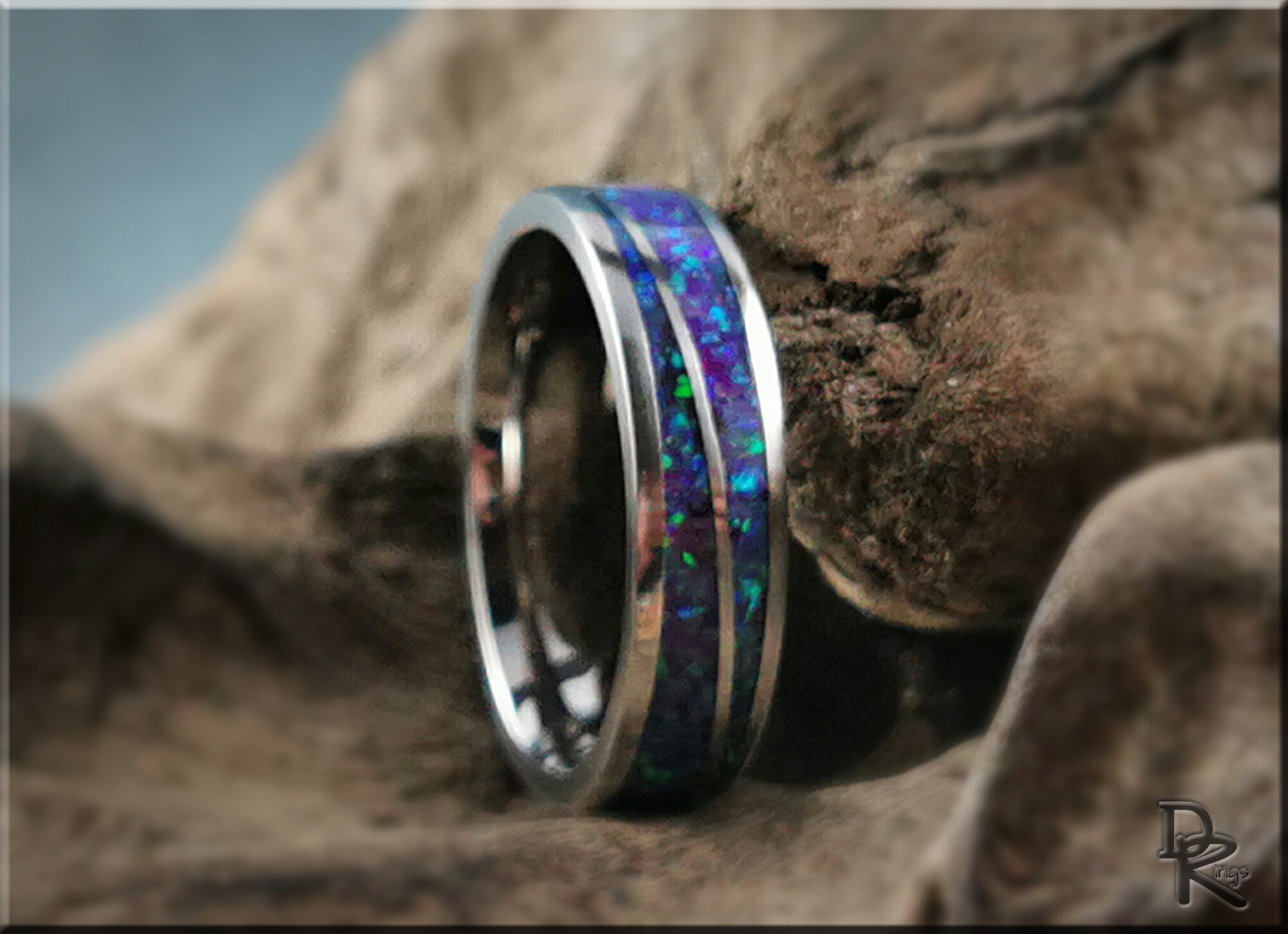 DR Rings titanium ring with opal featuring a vibrant blue and green opal inlay on a polished silver band