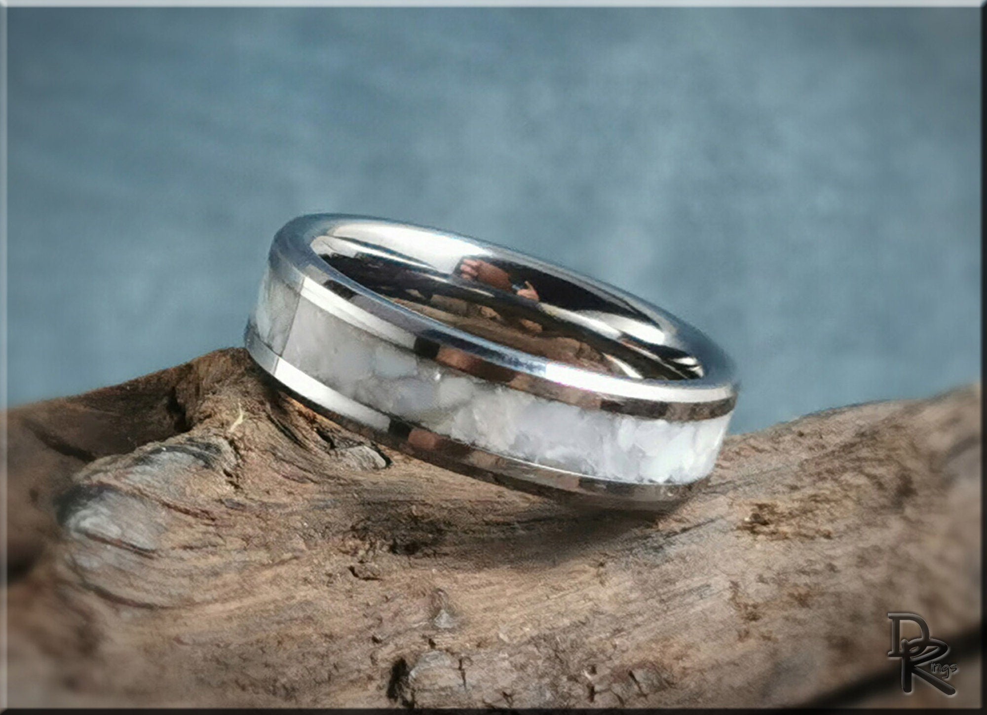 DR Rings tungsten ring with pearl inlay on rustic wooden surface with blue background