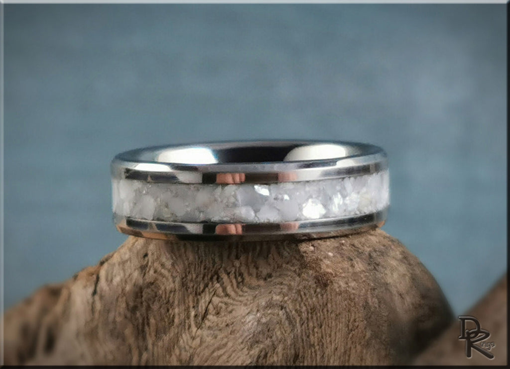 DR Rings tungsten ring with pearl inlay featuring a polished silver band on wooden surface