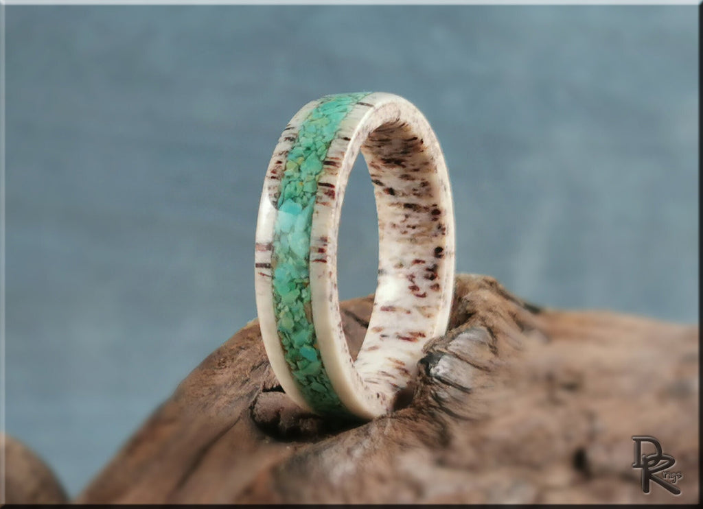 Antler ring with turquoise inlay by DR Rings displayed on rustic wood background
