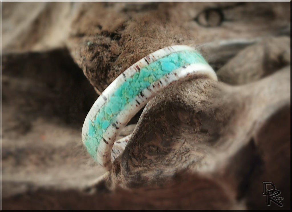 Antler ring with turquoise inlay by DR Rings displayed on natural wood background