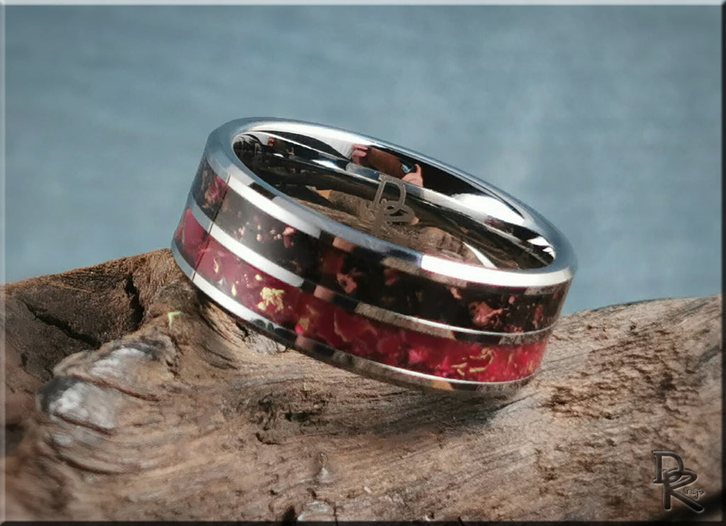 DR Rings tungsten carbide ring with inlay featuring red and black detailed design on wood background