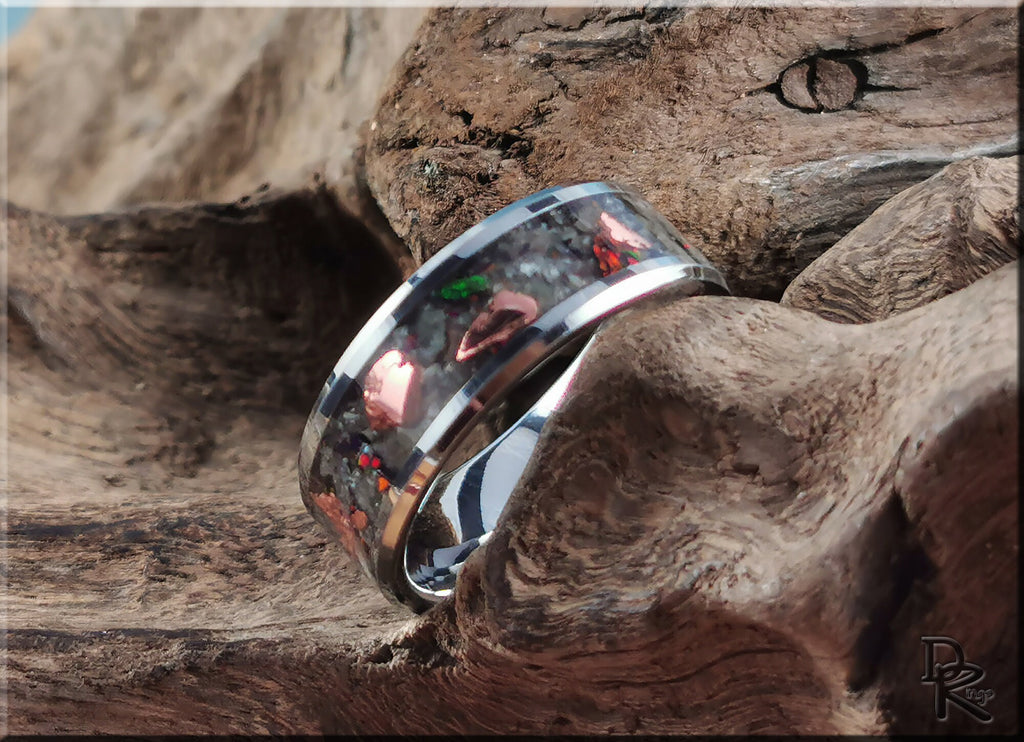 DR Rings tungsten ring carbide with yooperlite featuring vibrant inlay on textured wood background