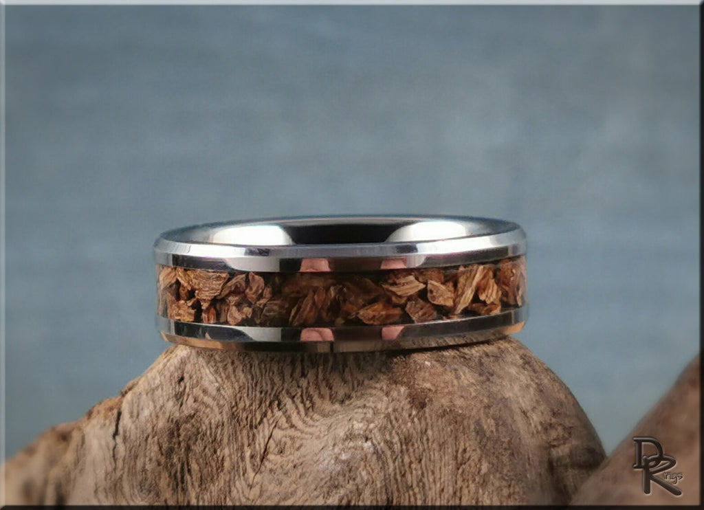 DR Rings tungsten ring with dinosaur bone inlay handcrafted on natural wood background