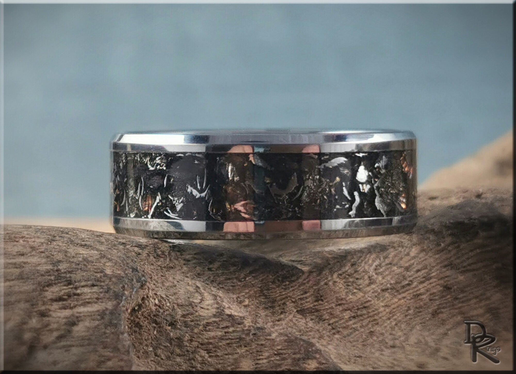 Tungsten ring with meteorite inlay by DR Rings featuring a polished silver band and textured black center