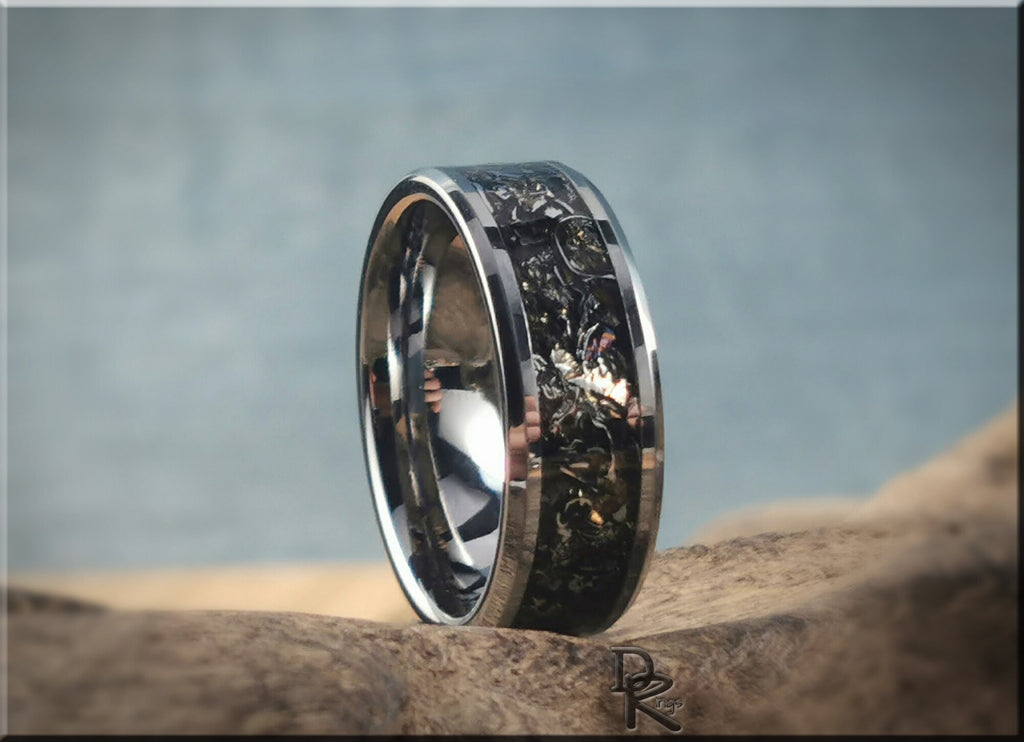 Tungsten ring with meteorite inlay featuring a polished silver finish on natural rock background