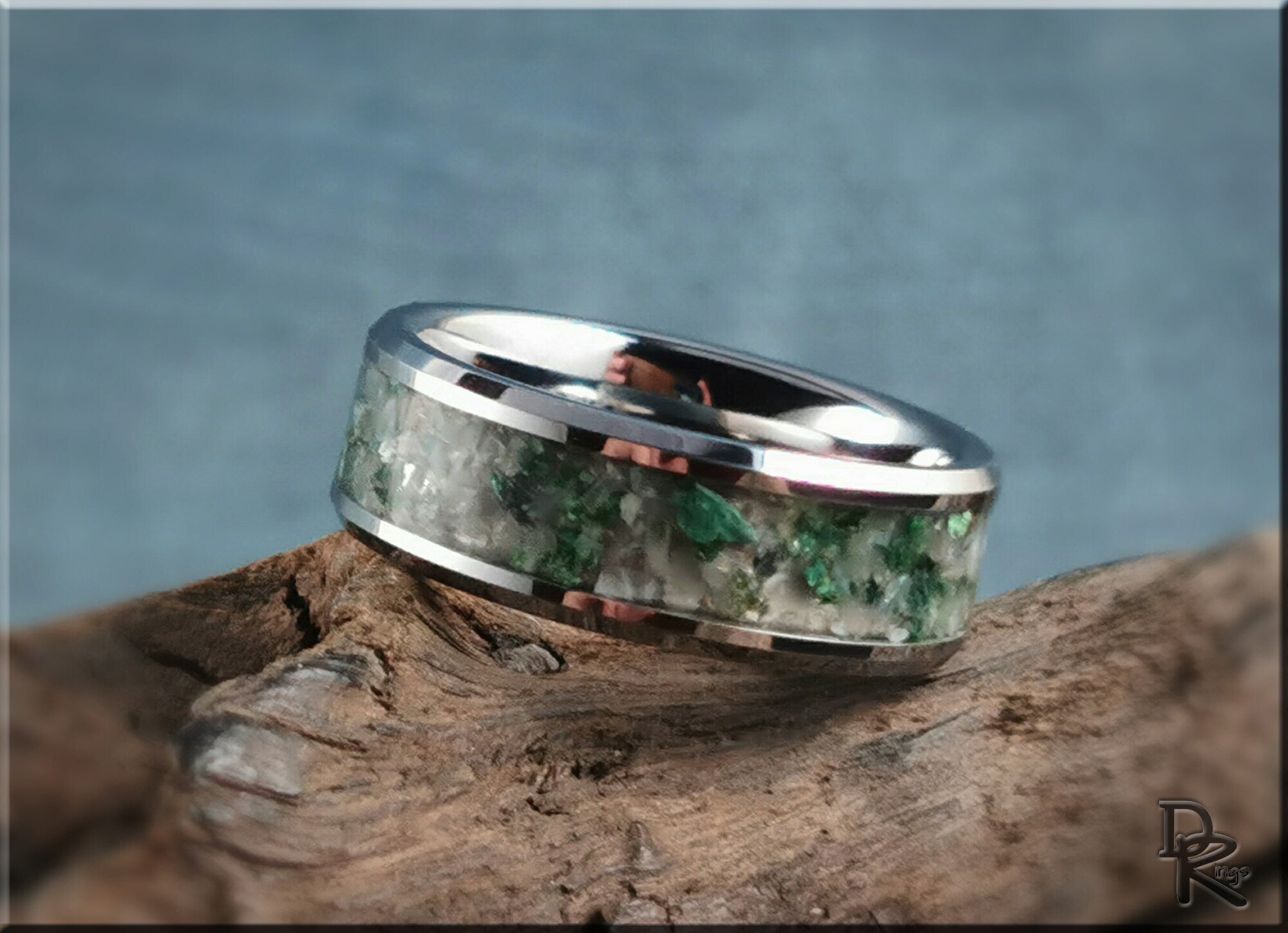DR Rings tungsten ring with moonstone inlay featuring green and white stones on rustic wood