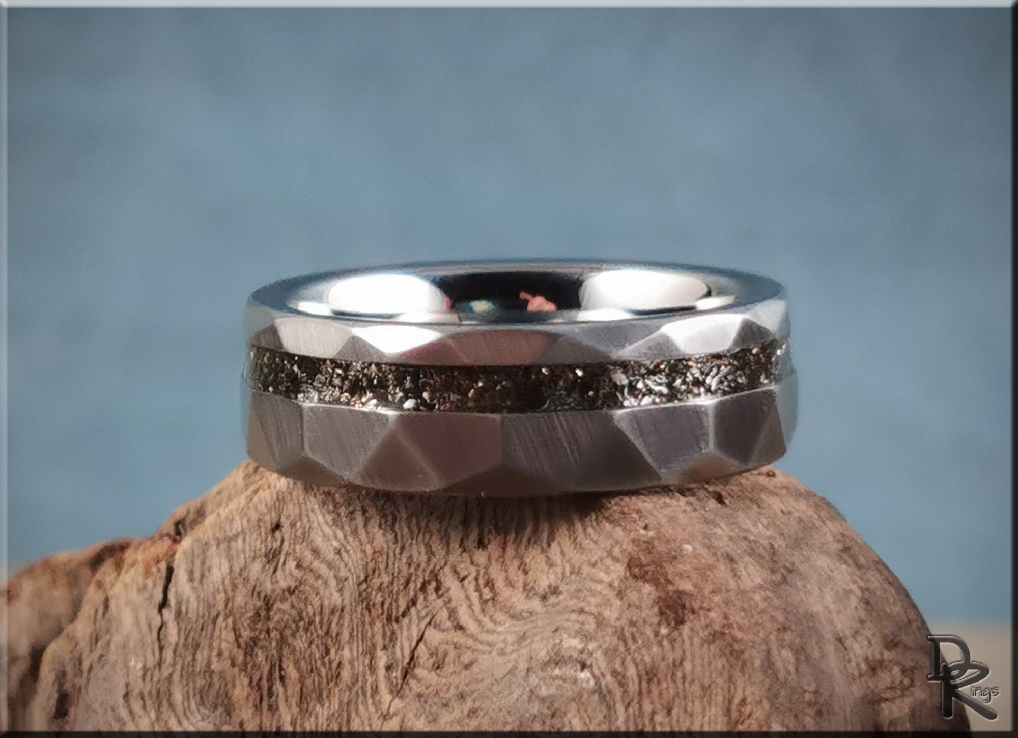 Hammered tungsten carbide ring with meteorite inlay on rustic wood background by DR Rings