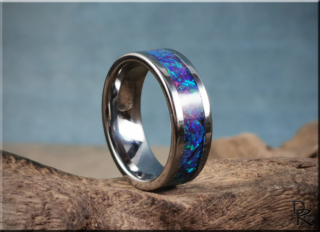 DR Rings super titanium ring with inlay featuring vibrant blue and purple colors on textured wood background