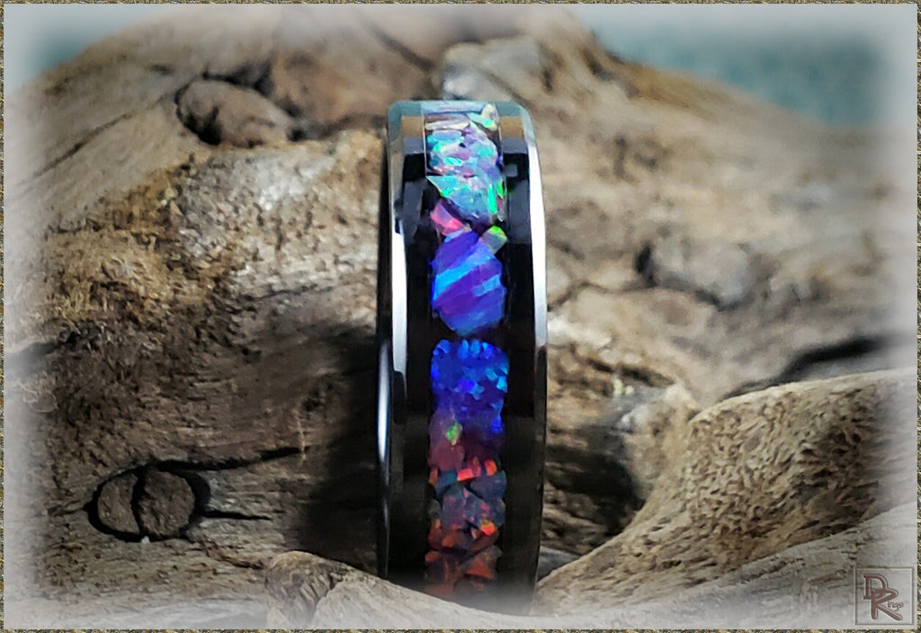 Oura ring 4 ceramic with iridescent inlay on black band displayed on textured wood background
