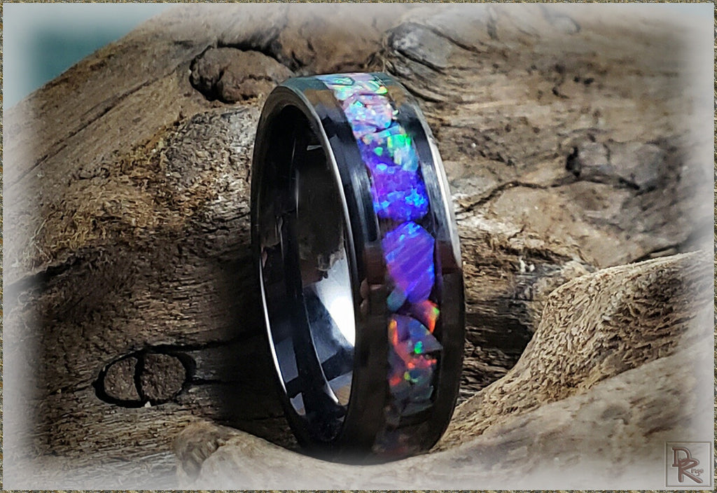 DR Rings oura ring 4 ceramic with colorful opal inlay on a rustic wooden background