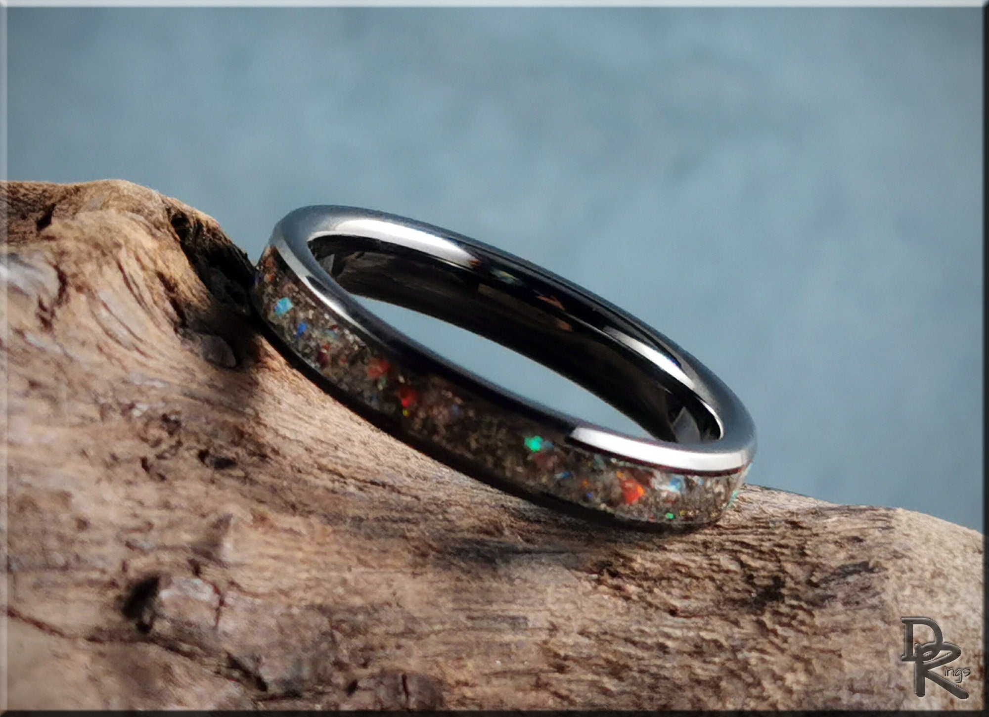 DR Rings ceramic ring with inlay featuring colorful reflective stones on a polished band