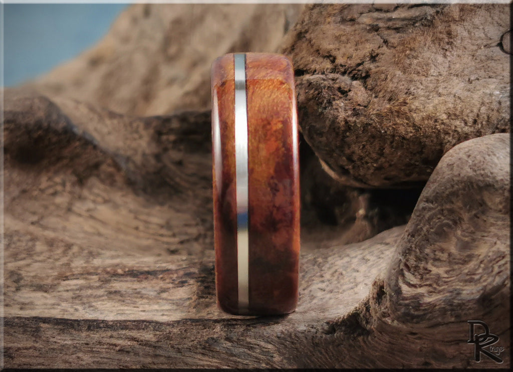 DR Rings handcrafted redwood ring with inlay featuring a sleek metal stripe on natural wood background
