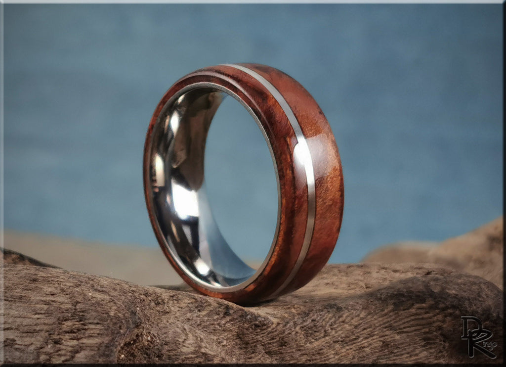 DR Rings polished redwood ring with inlay featuring a silver metal band on natural wood background
