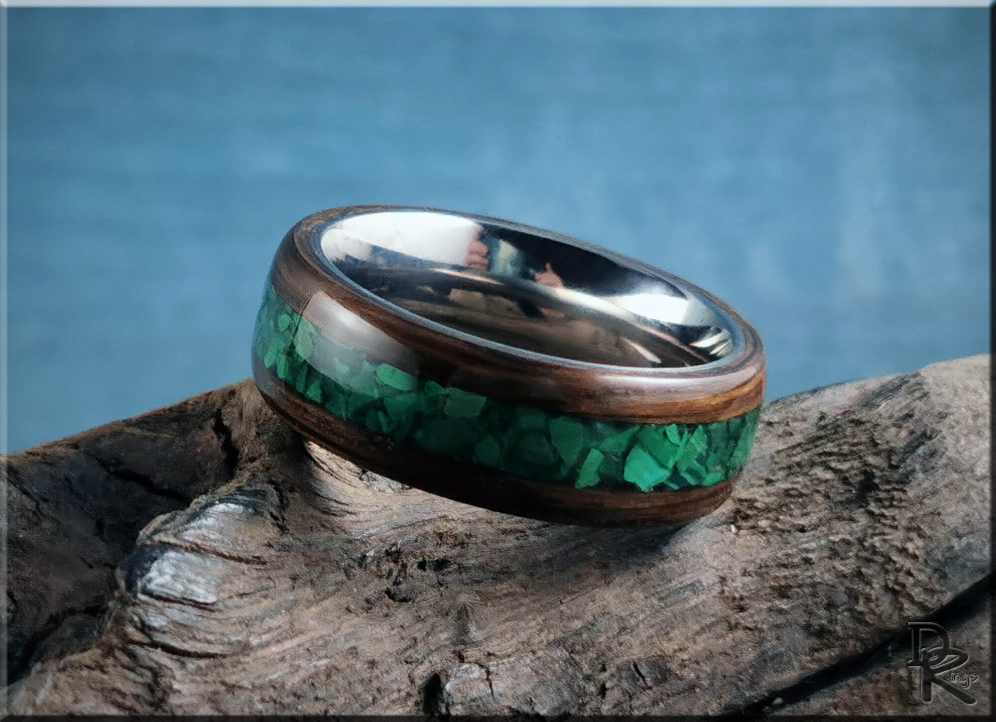 DR Rings band featuring ancient bog oak with malachite inlay on a textured wooden surface