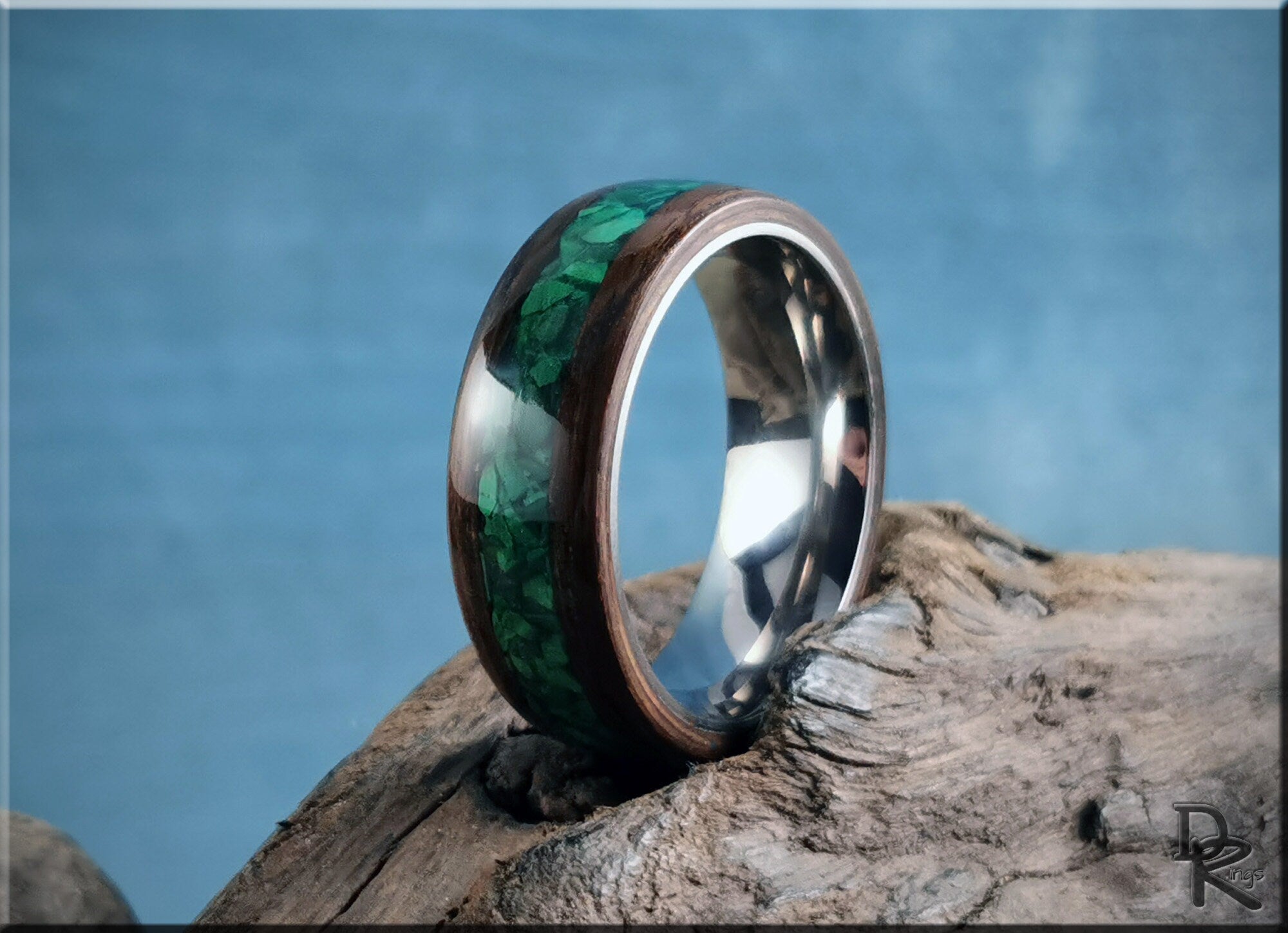 DR Rings band featuring ancient bog oak with malachite inlay on a rustic wooden surface