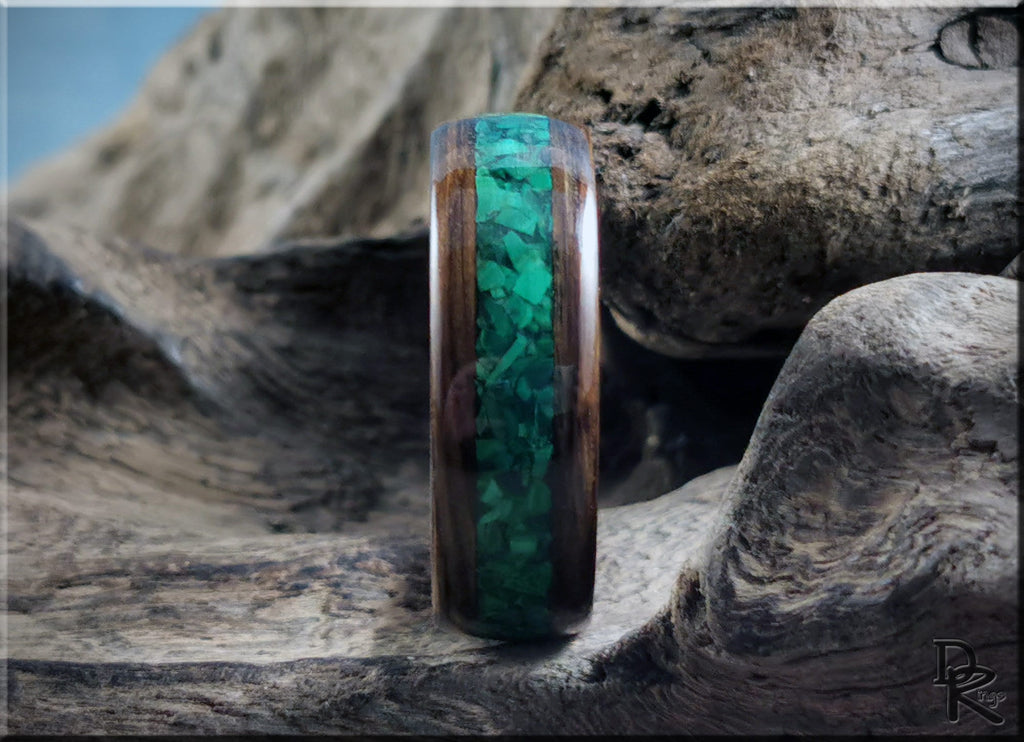 DR Rings wooden ring featuring ancient bog oak with malachite inlay on rustic wood background