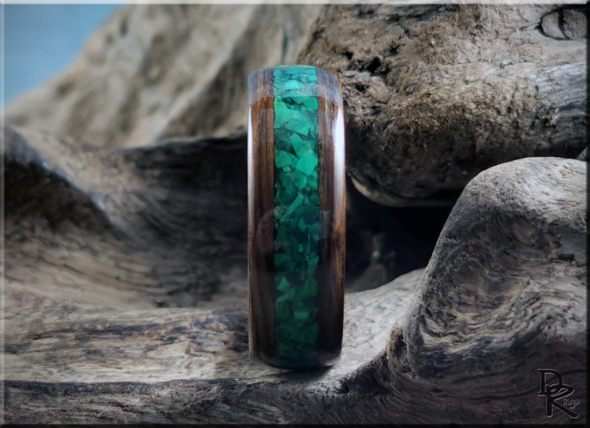 DR Rings wooden ring featuring ancient bog oak with malachite inlay on rustic wood background