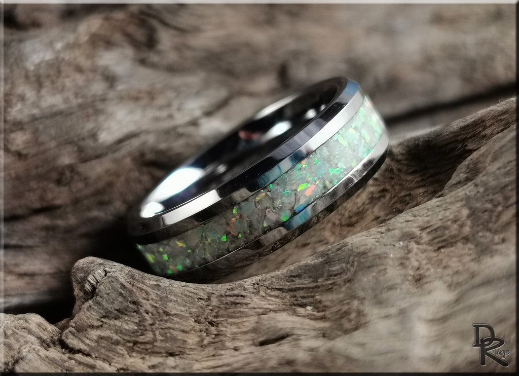 DR Rings ring opal with iridescent green opal inlay set in a polished silver band on rustic wood