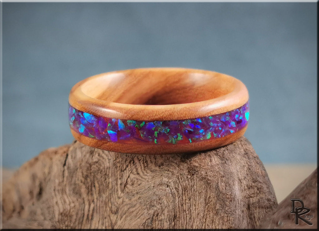 DR Rings wooden ring with vibrant blue and purple ring opal inlay on natural wood background