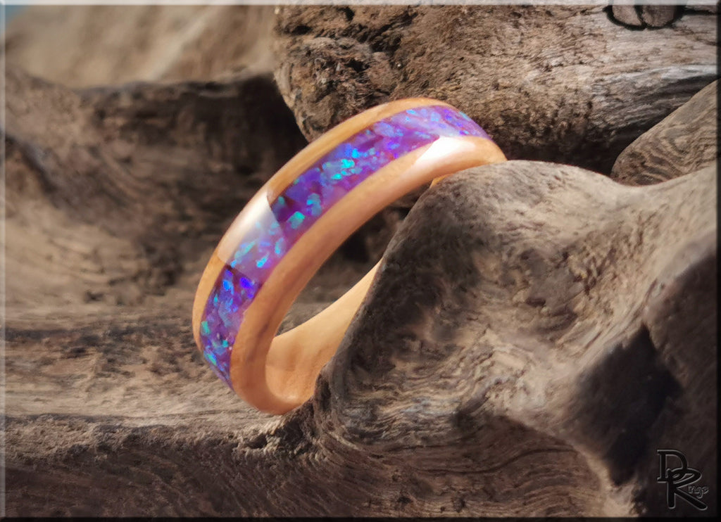 DR Rings wooden band ring opal inlay with vibrant blue and purple hues on natural wood background