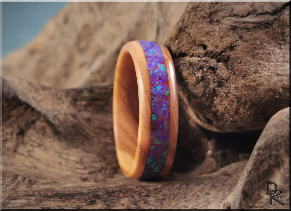DR Rings wooden band ring opal inlay with vibrant blue and purple colors on rustic background