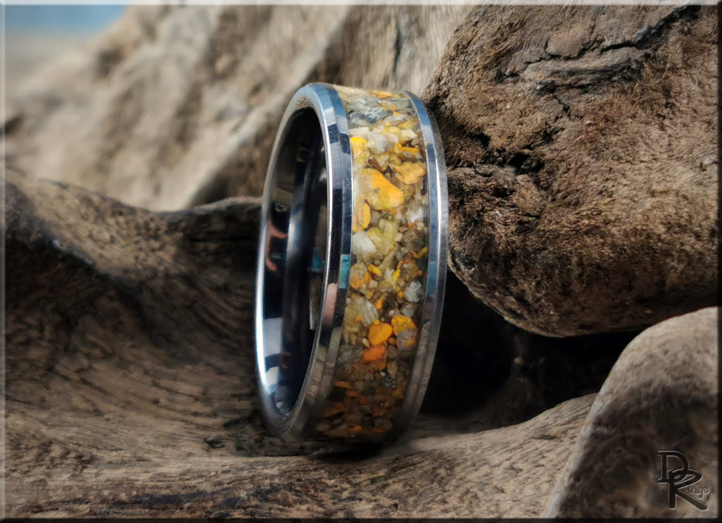 DR Rings tungsten ring with jasper inlay featuring earthy yellow and brown tones on a natural wood background