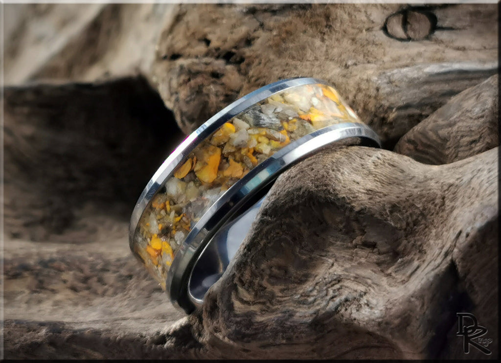 DR Rings tungsten ring with jasper inlay featuring yellow and brown stone details on a textured wooden background