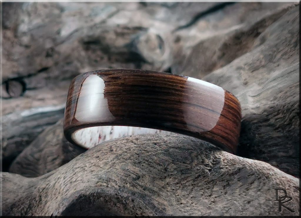 DR Rings polished bog oak wood ring with smooth finish placed on natural wood texture background
