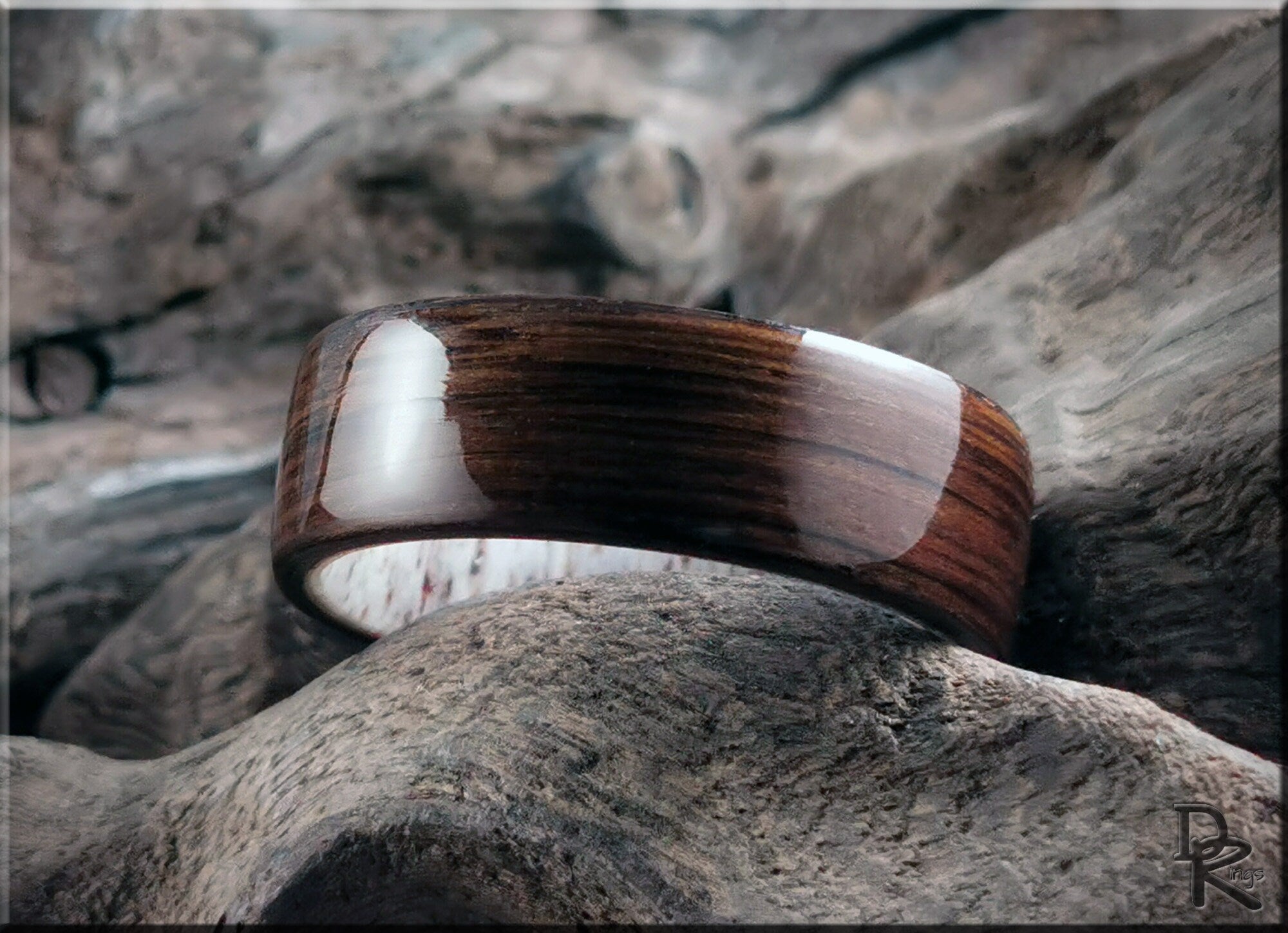 DR Rings polished bog oak wood ring with smooth finish placed on natural wood texture background
