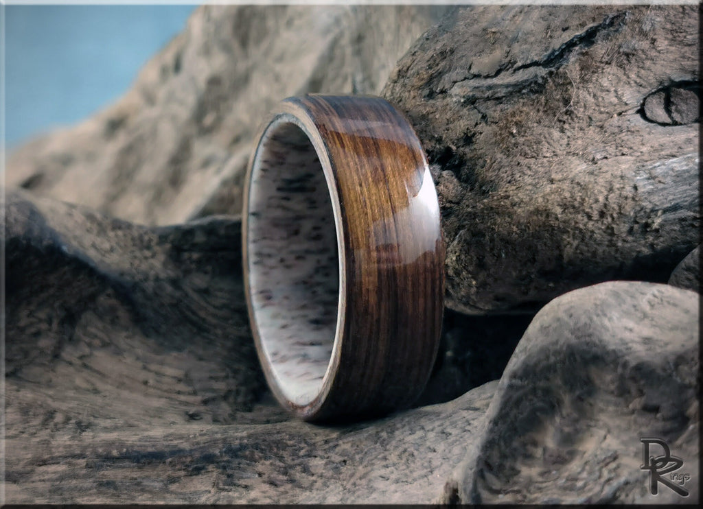 DR Rings bog oak wooden ring with glossy finish resting on textured wood background