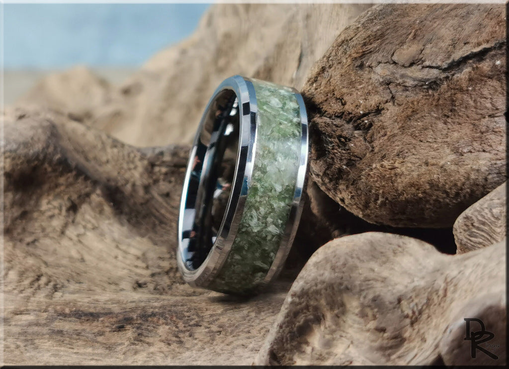 DR Rings tungsten ring with jade inlay placed on textured natural wood background